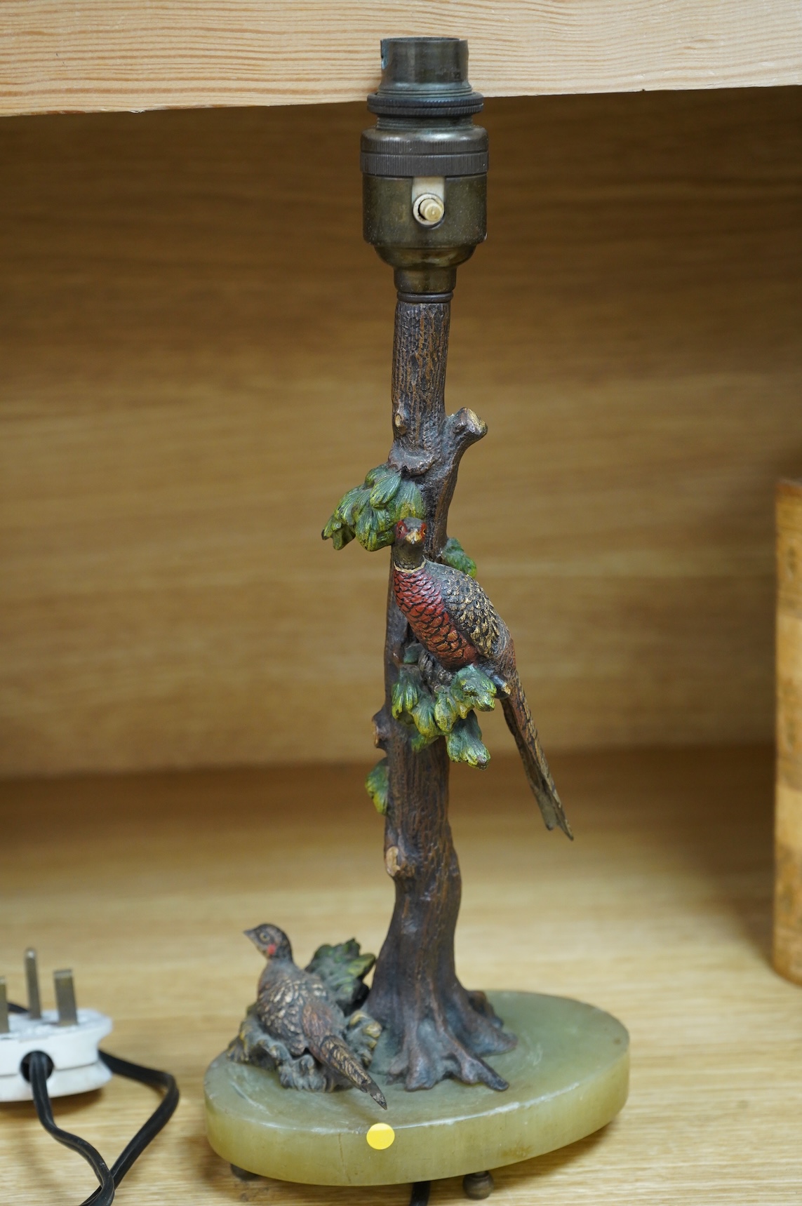 In the manner of Franz Xaver Bergmann (1861-1936), an Austrian cold painted bronze table lamp in the form a tree with pheasants, on green onyx oval base, unmarked, 34cm high including fitting